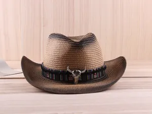 Close-up of western straw cowboy hat featuring bull skull metal buckle and woven band