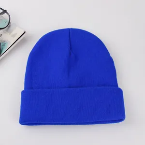 Detailed knit texture of solid navy blue winter beanie hat with wide folded cuff