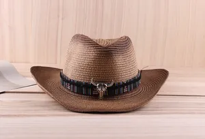 Detail of western straw hat featuring a gradient finish and a metallic bull skull ornament