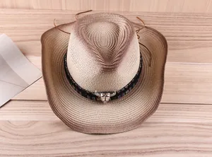 Detailed close-up of a gradient straw cowboy hat with a bull head silver emblem