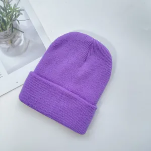 Détail d'un bonnet en maille côtelée violette présentant une texture épaisse et un revers