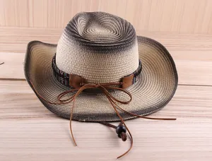 Detail of woven straw cowboy hat featuring ethnic style ribbon and adjustable chin strap