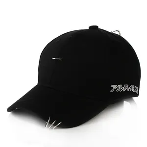 Close-up of black cotton baseball cap with silver metal rings and side embroidery