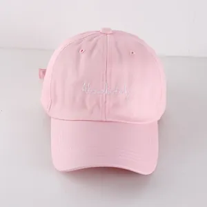 Close-up of pink cotton canvas baseball cap featuring white Absolutely letter embroidery