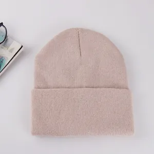 Classic knitted beanie in light pink with rolled cuff design for autumn winter warmth