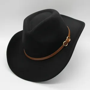 Detail of wool fedora featuring a brown leather band and gold buckle on a black felt hat