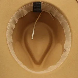 Detail of adjustable inner strap and care label inside a camel felt cowboy hat