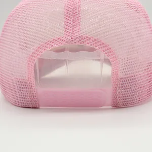 Close-up of pink mesh trucker hat featuring adjustable snapback and breathable back panels