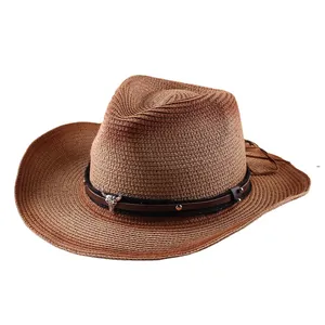 Western straw cowboy hat with ethnic leather band and silver bull skull metal ornament