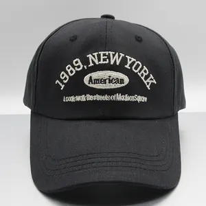 Detailed close-up of 1989 New York white embroidery on black cotton baseball cap