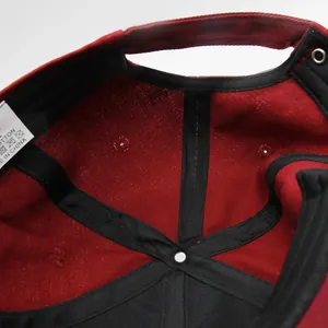 Macro shot of baseball cap interior showing black reinforcement tapes and cotton wash label