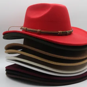 Detailed stack of felt western cowboy hats with leather bands and metal skull ornaments