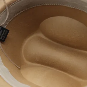 Macro detail of the camel felt cowboy hat interior showing the cotton sweatband and label