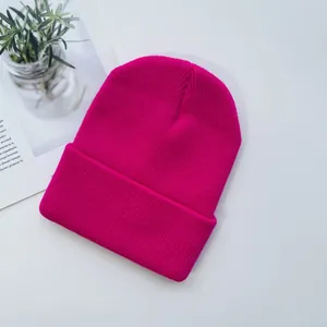 Rose red knit beanie for children with ribbed texture and folded cuff for winter warmth