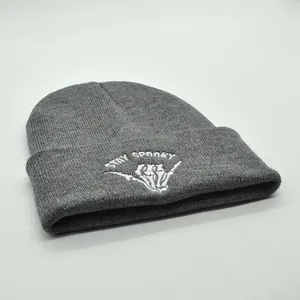 Close-up of Stay Spooky embroidery and skeleton hand on gray knit beanie cap
