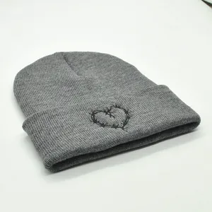 Grey knit beanie featuring black heart embroidery detail for winter outdoor warmth