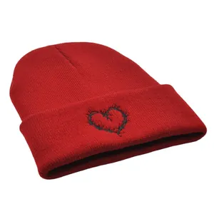 Red winter beanie with black thorn heart embroidery and premium ribbed knit texture