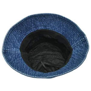 Detail of blue denim bucket hat showing black inner lining and adjustable drawstring cord