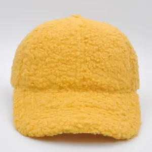 Detail shot of bright yellow sherpa fleece baseball cap texture and curved brim