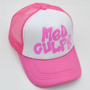 Detailed view of pink and white mesh trucker hat with 3D Mea Culpa puff lettering