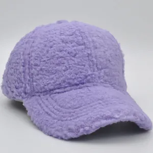 Detail shot of the thick lavender teddy fleece texture on a warm winter baseball cap