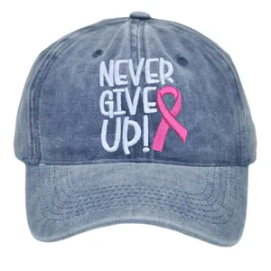 Washed blue denim baseball cap featuring Never Give Up embroidery and pink ribbon logo