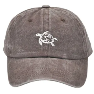 Vintage washed brown baseball cap with embroidered white sea turtle on cotton fabric
