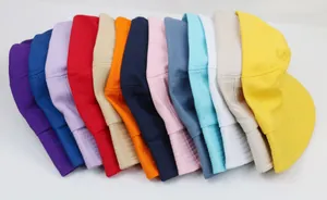 Detailed close-up showing a stack of colorful cotton bucket hats in thirteen vibrant shades