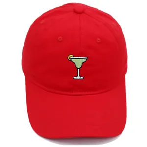 Close-up of red cotton baseball cap featuring detailed Margarita cocktail embroidery