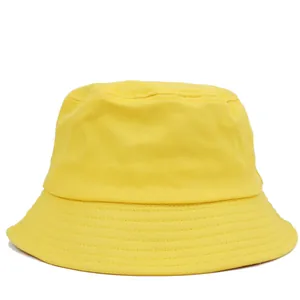 Close-up of bright yellow cotton bucket hat featuring reinforced stitching on the brim