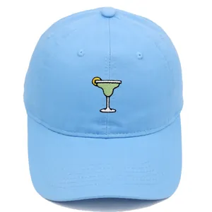 Close-up of light blue cotton baseball cap featuring detailed Margarita glass embroidery