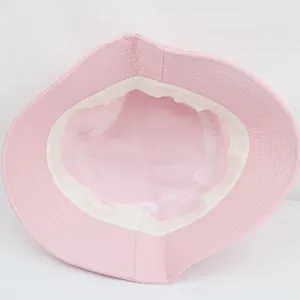 Detail view showing the pink bucket hat interior with reinforced white sweatband stitching
