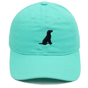 Close-up of mint green cotton baseball cap featuring black dog silhouette embroidery