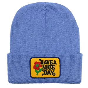 Blue knit beanie with Have a Nice Day yellow patch and red flower embroidery