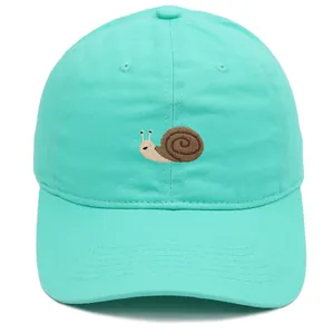 Close-up of detailed snail embroidery on a mint green breathable cotton baseball cap