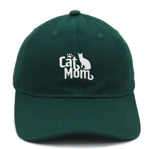 Detailed white Cat Mom embroidery on a dark green cotton baseball cap with curved brim
