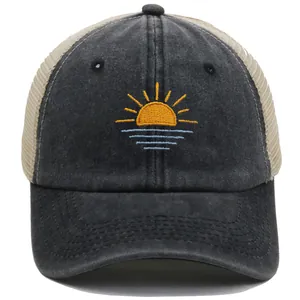 Close-up of sunset embroidery on dark grey washed cotton with beige mesh back