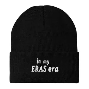 Detailed view of white in my ERAS era embroidery on black knit beanie cuff