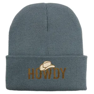 Close-up of HOWDY embroidery with cowboy hat icon on dark blue knit beanie hat