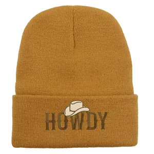 Mustard yellow knit beanie with brown HOWDY embroidery and cowboy hat icon for winter