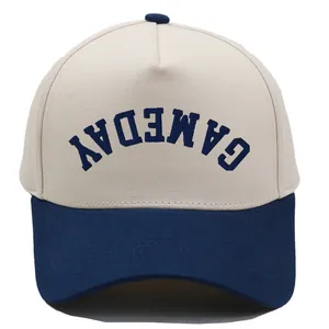 Close-up of navy GAMEDAY embroidery on a two-tone cotton twill 5-panel baseball cap