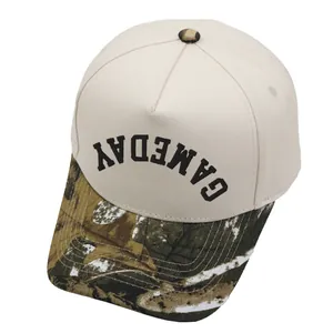 Close-up of 5-panel Gameday baseball cap featuring beige canvas and camo print brim