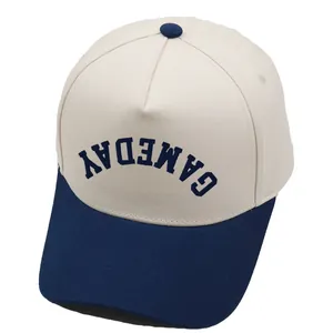 Close-up of five-panel baseball cap showing blue GAMEDAY lettering and stitch detail