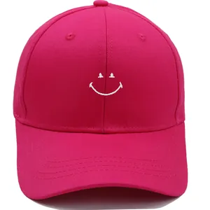 Close-up of smile embroidery on rose red cotton baseball cap with reinforced brim