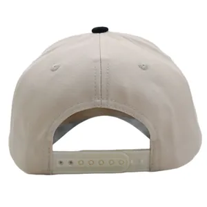 Beige baseball cap with snapback closure and black top button on white background