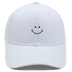White baseball cap with minimalist black embroidered smile face and curved brim