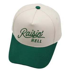 Raisin Hell embroidered baseball cap with cream crown and dark green brim on white background