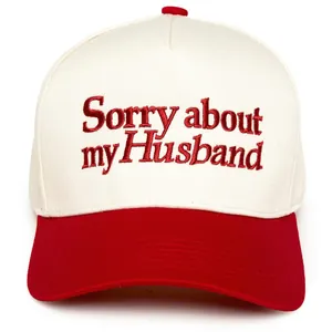 Detail of Sorry about my Husband embroidery on red and white cotton trucker hat
