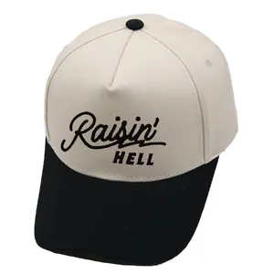 Two-tone Raisin Hell embroidered baseball cap with cream crown and black brim in five-panel style