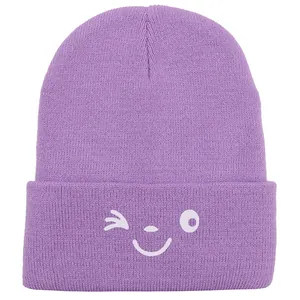 Light purple knitted beanie with white winking face embroidery for winter warmth